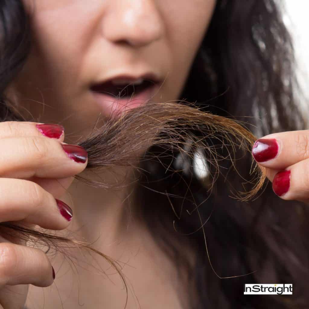 women checking whether heat-damaged hair vs healthy hair she is 